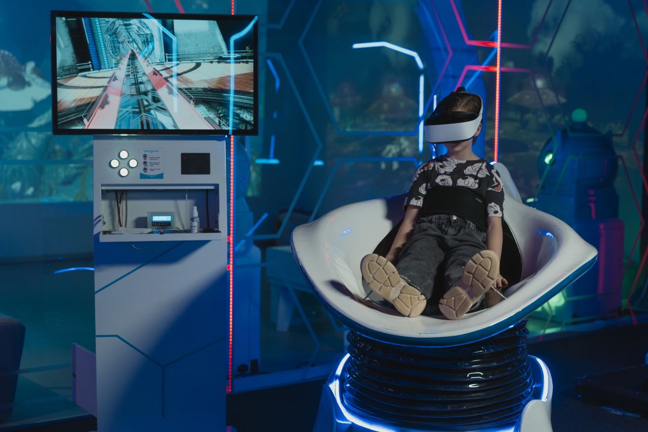 services-09 A child immersed in a futuristic virtual reality game with neon lights and advanced technology.